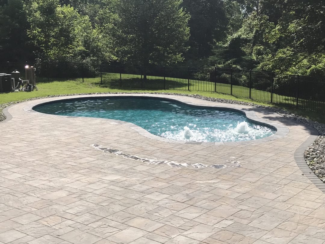 Freeform pool with bubblers and pool decking